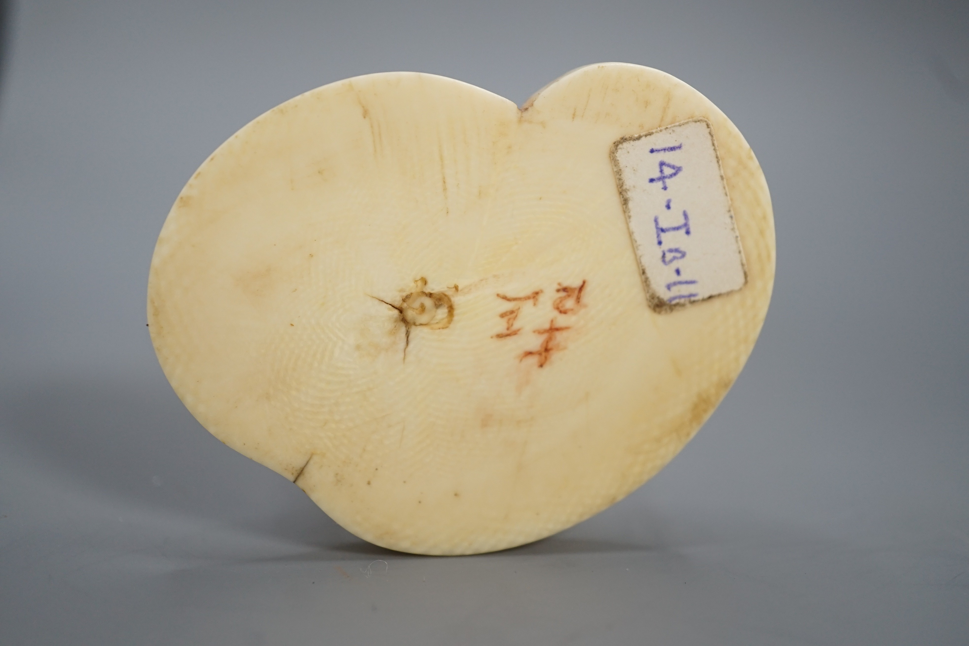 A Japanese ivory okimono of a cormorant fisherman, signed, Meiji period, 11cm and a small carving of a monkey